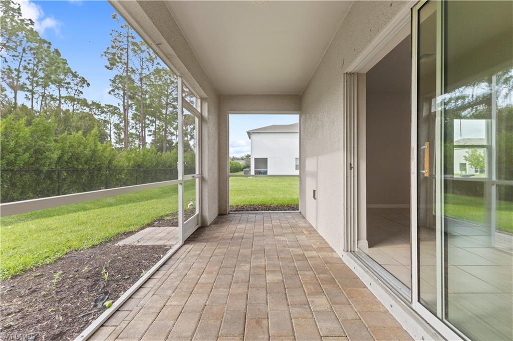 15245 Wildflower Circle Naples, FL 34119 - Photo 27 of 36 a view of a porch with a yard