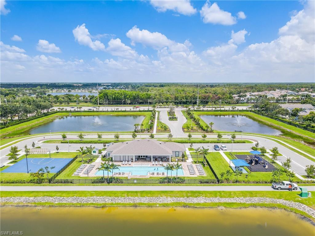 15245 Wildflower Circle Naples, FL 34119 - Photo 28 of 36 a view of a swimming pool with an ocean view