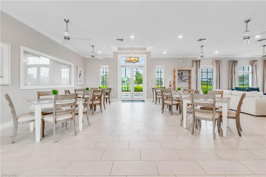 15245 Wildflower Circle Naples, FL 34119 - Photo 32 of 36 a view of a dining area with furniture