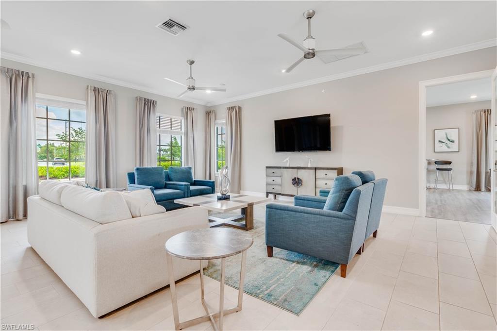 15245 Wildflower Circle Naples, FL 34119 - Photo 33 of 36 a living room with furniture and a flat screen tv