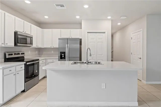 a kitchen with stainless steel appliances a refrigerator stove microwave and cabinets