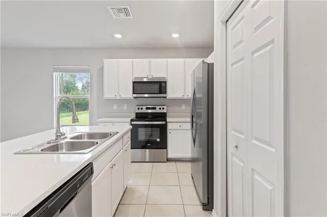 a kitchen with a sink appliances and cabinets