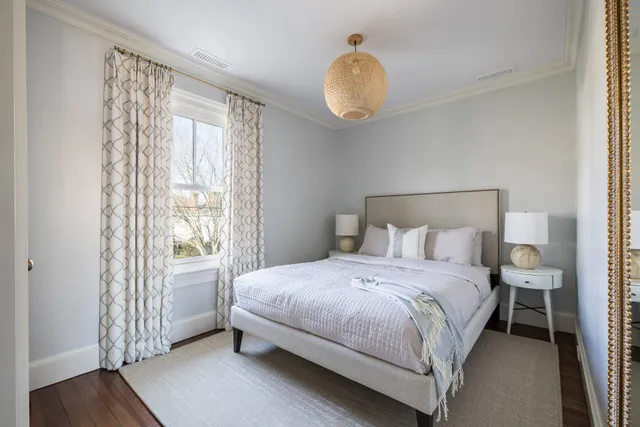 a bedroom with a bed and wooden floor