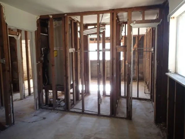 a view of an empty room with floor to ceiling window and window