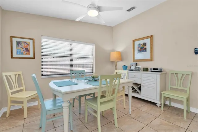 a view of a dining room with furniture and a window