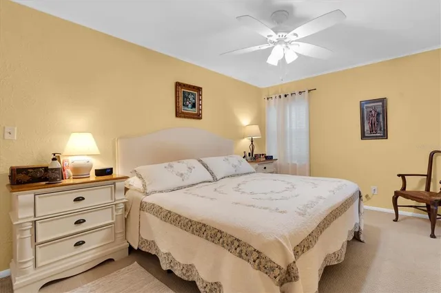 a spacious bedroom with a bed and a table in it