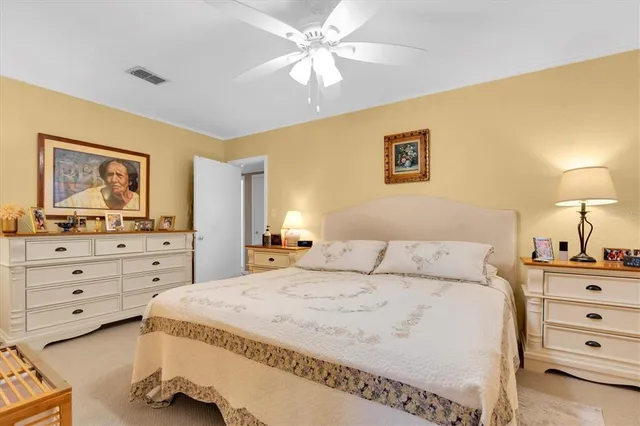 a spacious bedroom with a bed and a dresser