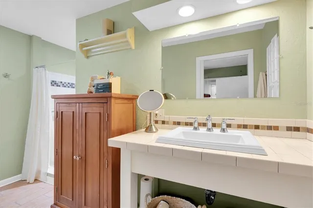 a bathroom with a sink vanity and a mirror