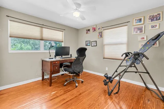 a view of a workspace with furniture and a window