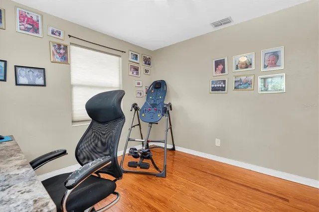 a view of workspace with wooden floor lounge chair and painted walls