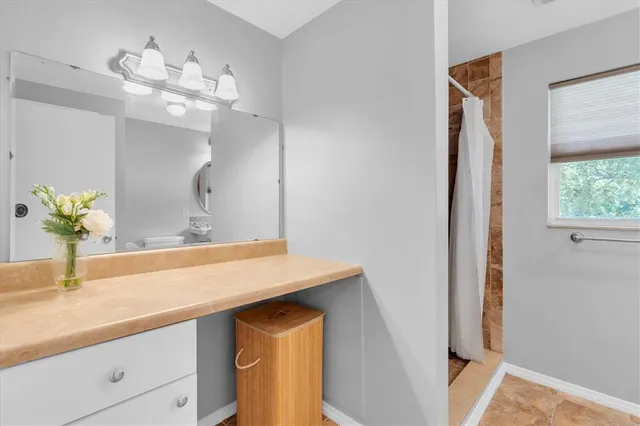 a bathroom with a sink a vanity and a mirror