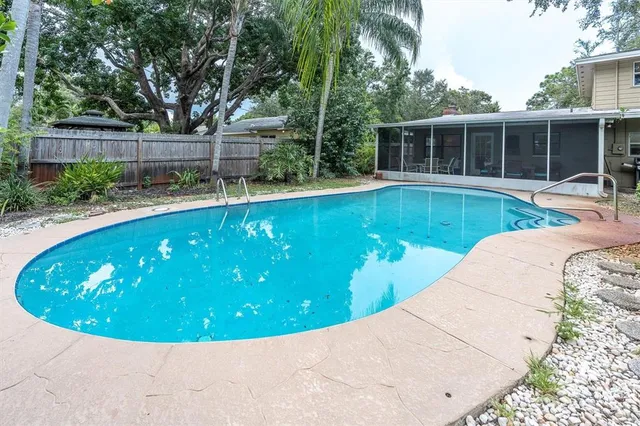 a view of a swimming pool with two chairs