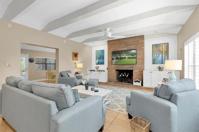 a living room with furniture a window and a fireplace