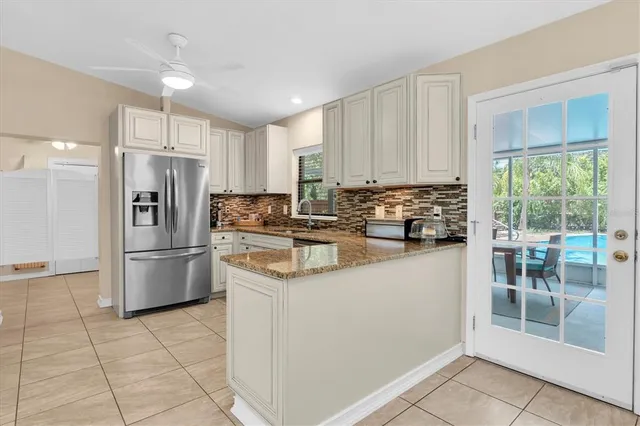 a kitchen with a refrigerator a stove a washer and dryer