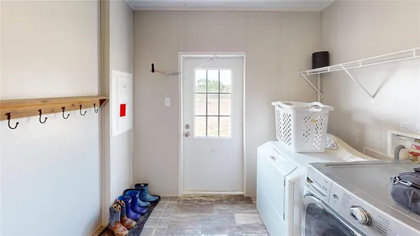 a view of storage and utility room with two washing machine