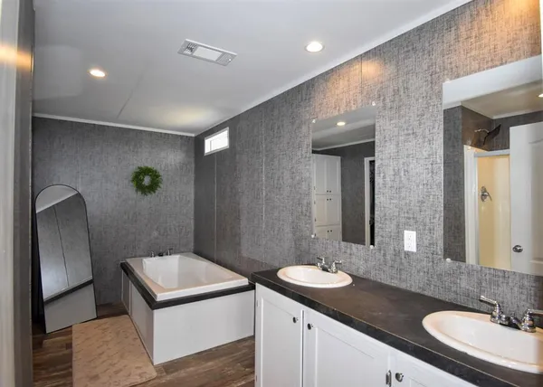 a bathroom with a granite countertop sink a toilet and mirror