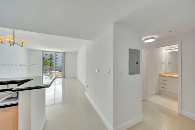 a view of a kitchen with white cabinets and stainless steel appliances