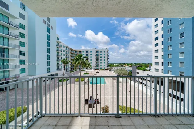 a swimming pool with buildings in the background