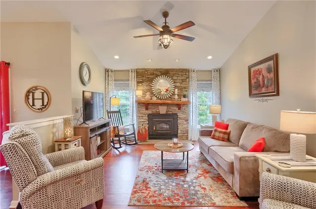 a living room with furniture a fireplace and a flat screen tv