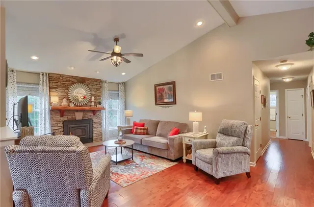 a living room with furniture fireplace and flat screen tv