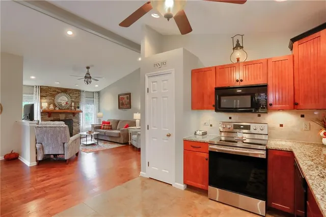 a kitchen with stainless steel appliances a stove sink microwave and cabinets