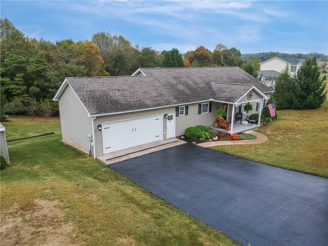 a aerial view of a house next to a yard