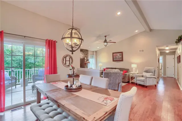 a living room with furniture a rug and a floor to ceiling window