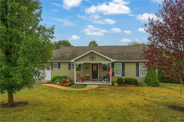 a front view of a house with swimming pool and porch