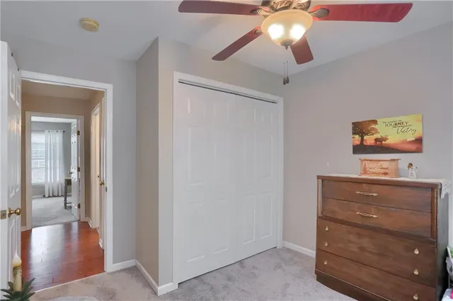 a view of a hallway with a livingroom and a chandelier