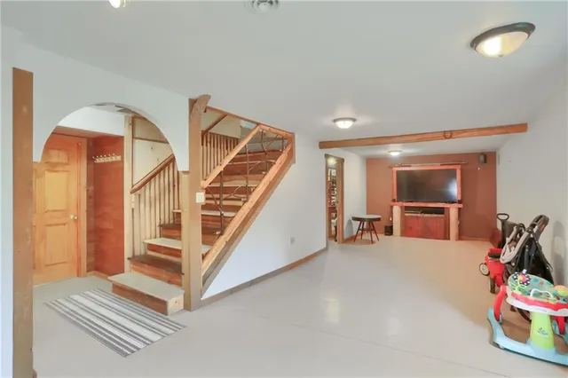 a view of a livingroom with furniture and stairs
