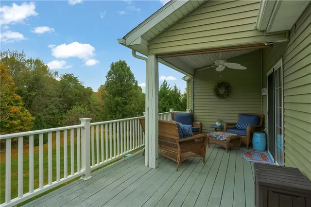 a view of a balcony with chairs and wooden floor