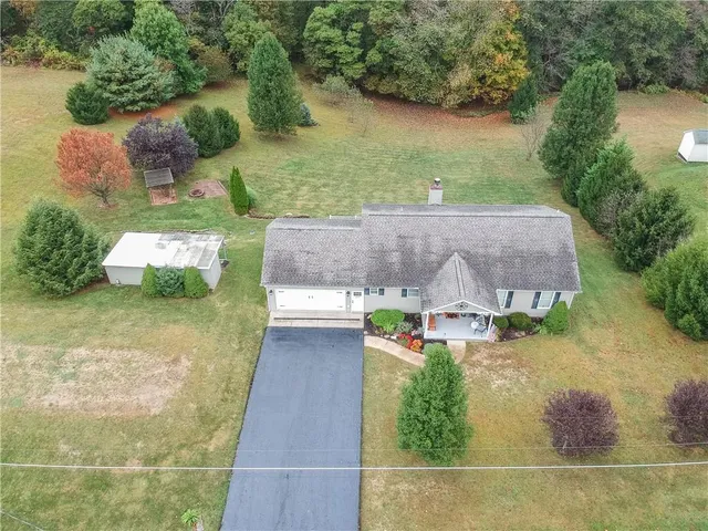 an aerial view of a house with outdoor space and lake view