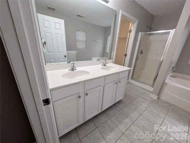 a bathroom with a double vanity sink and mirror