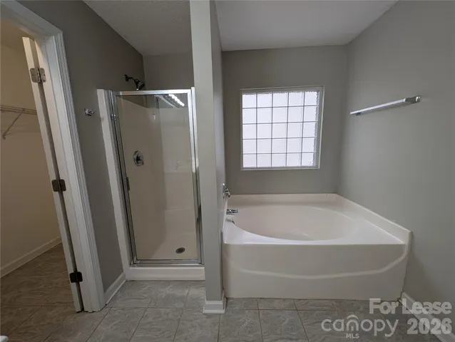 a bathroom with a tub and a shower