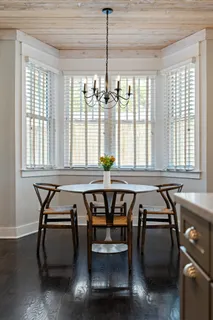 a living room with furniture fireplace and a large window