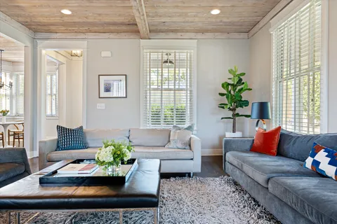 a bedroom with a bed and a table with wooden floor
