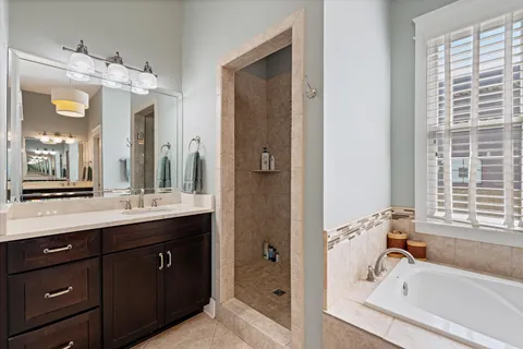 a bedroom with a bed and a lamp on dresser