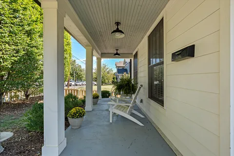 a kitchen with stainless steel appliances granite countertop a stove a refrigerator a sink a white with a dining table and chairs