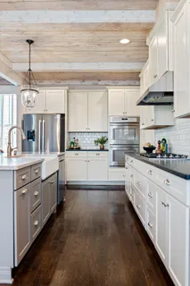 a view of a hallway with entryway and wooden floor