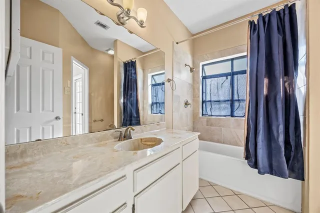 a bathroom with a tub sink and mirror