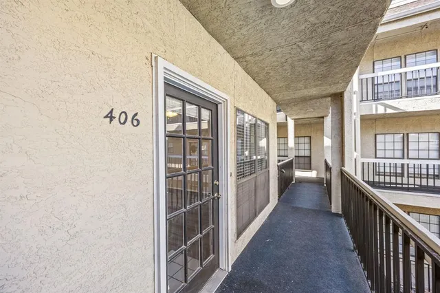 a view of a hallway with wooden floor and windows