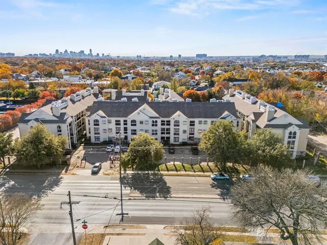 an aerial view of residential houses with city view