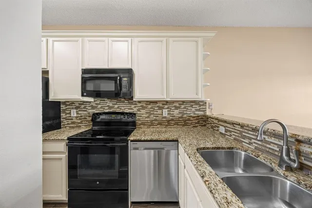 a kitchen with sink a microwave and stove