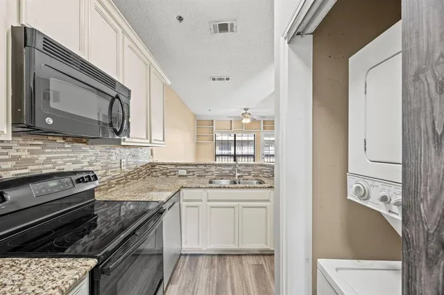 a kitchen with stainless steel appliances granite countertop a stove and a microwave