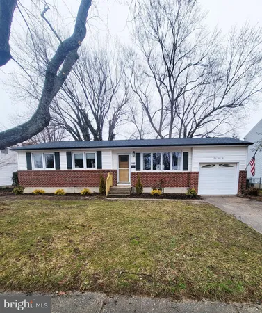 a house that has a big tree in front of a house