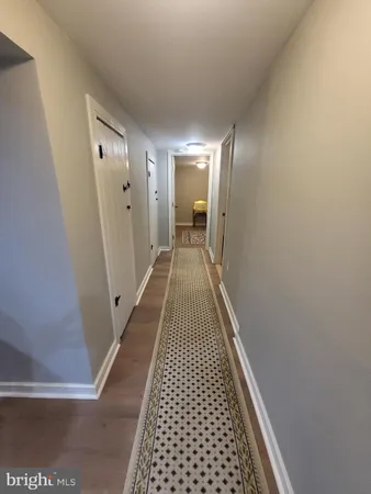 a bedroom with bed and wooden floor