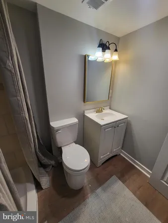 a white toilet sitting next to a bathroom sink