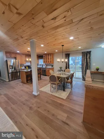 a living room with lots of furniture and kitchen view