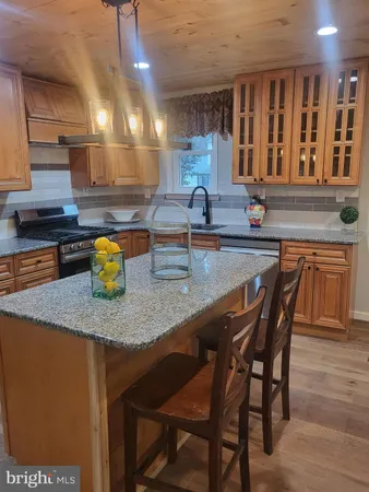 a kitchen with a sink a counter space and cabinets