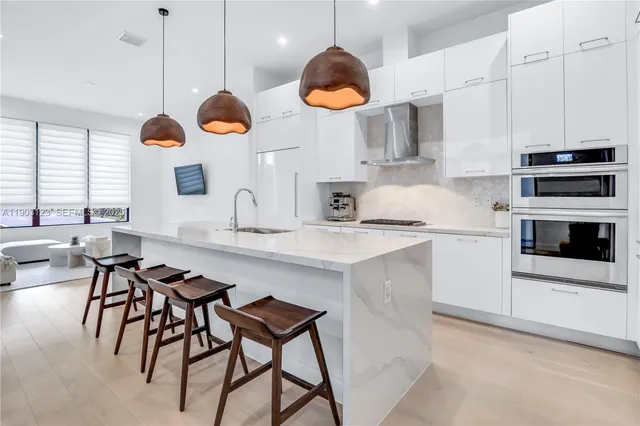 a kitchen with a refrigerator and a sink